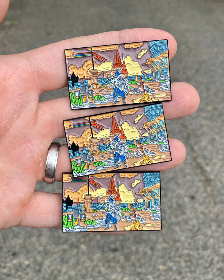 Three Dark Souls Praise the Sun enamel pins held in hand