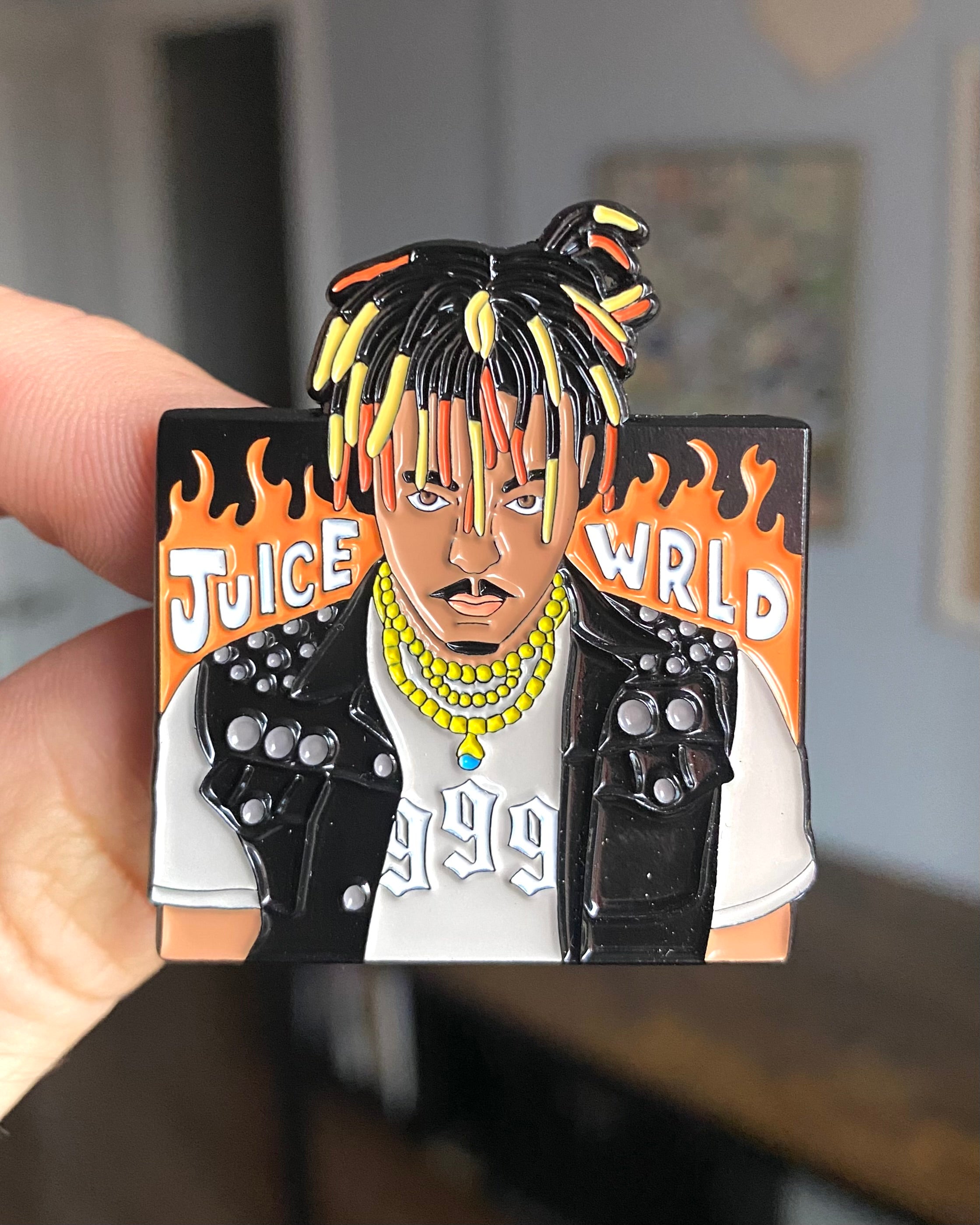 Juice WRLD 999 enamel pin held in hand