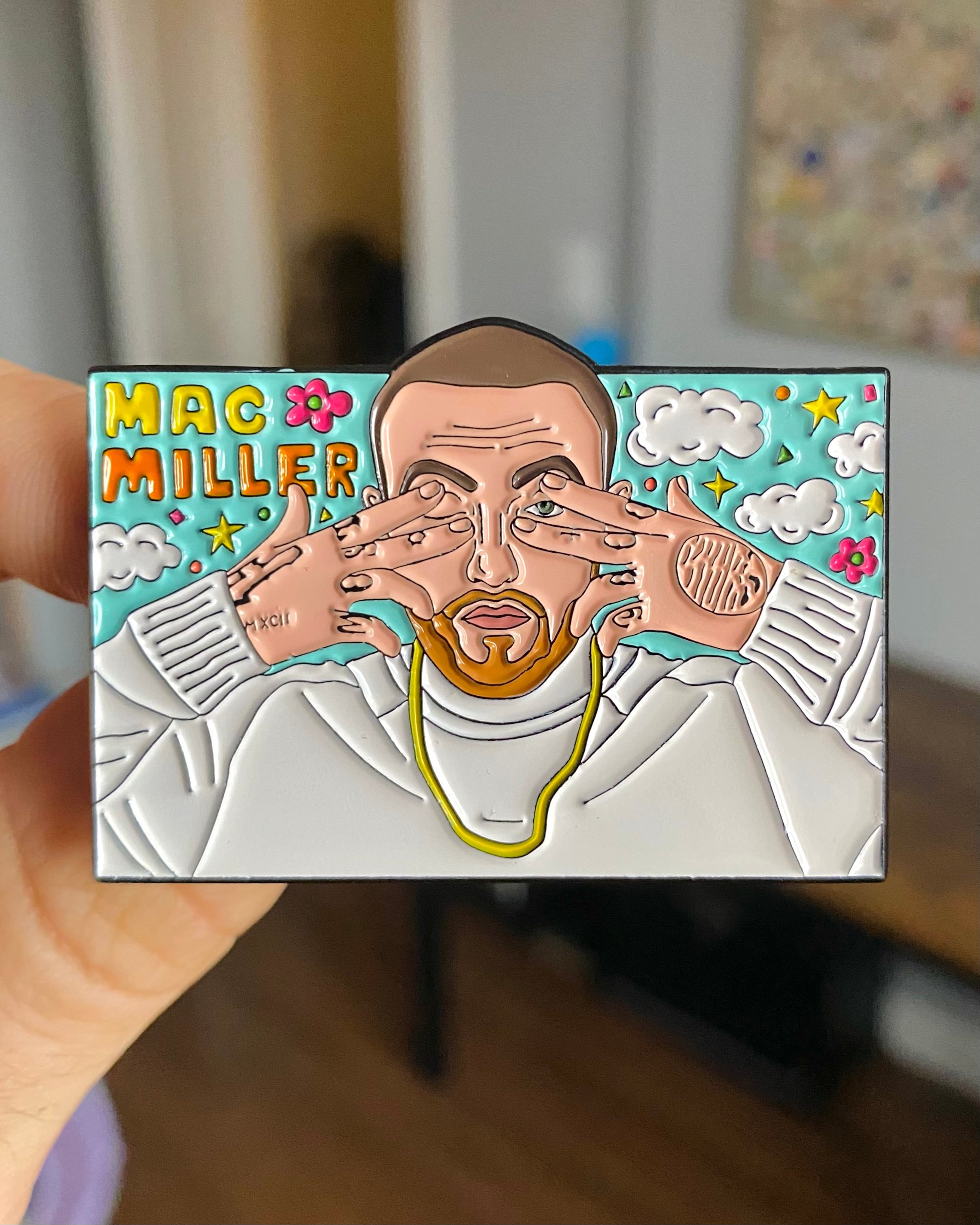 Mac Miller Dont Trip enamel pin held in hand