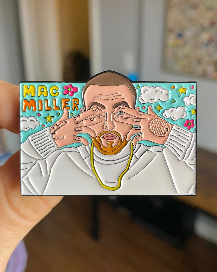 Mac Miller Dont Trip enamel pin held in hand