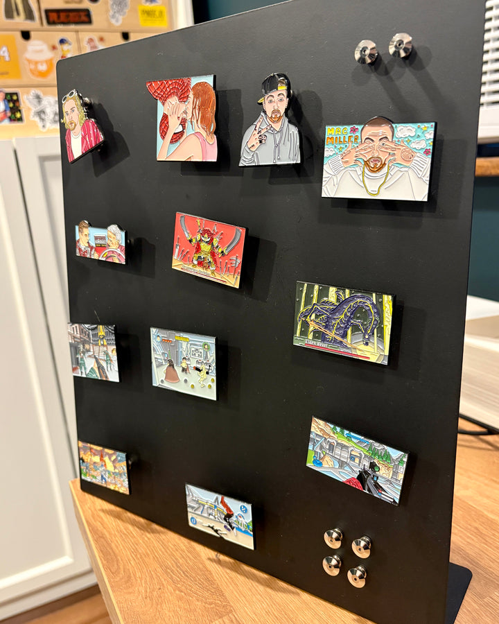 Enamel pins displayed as magnets on a board using magnetic pin backings