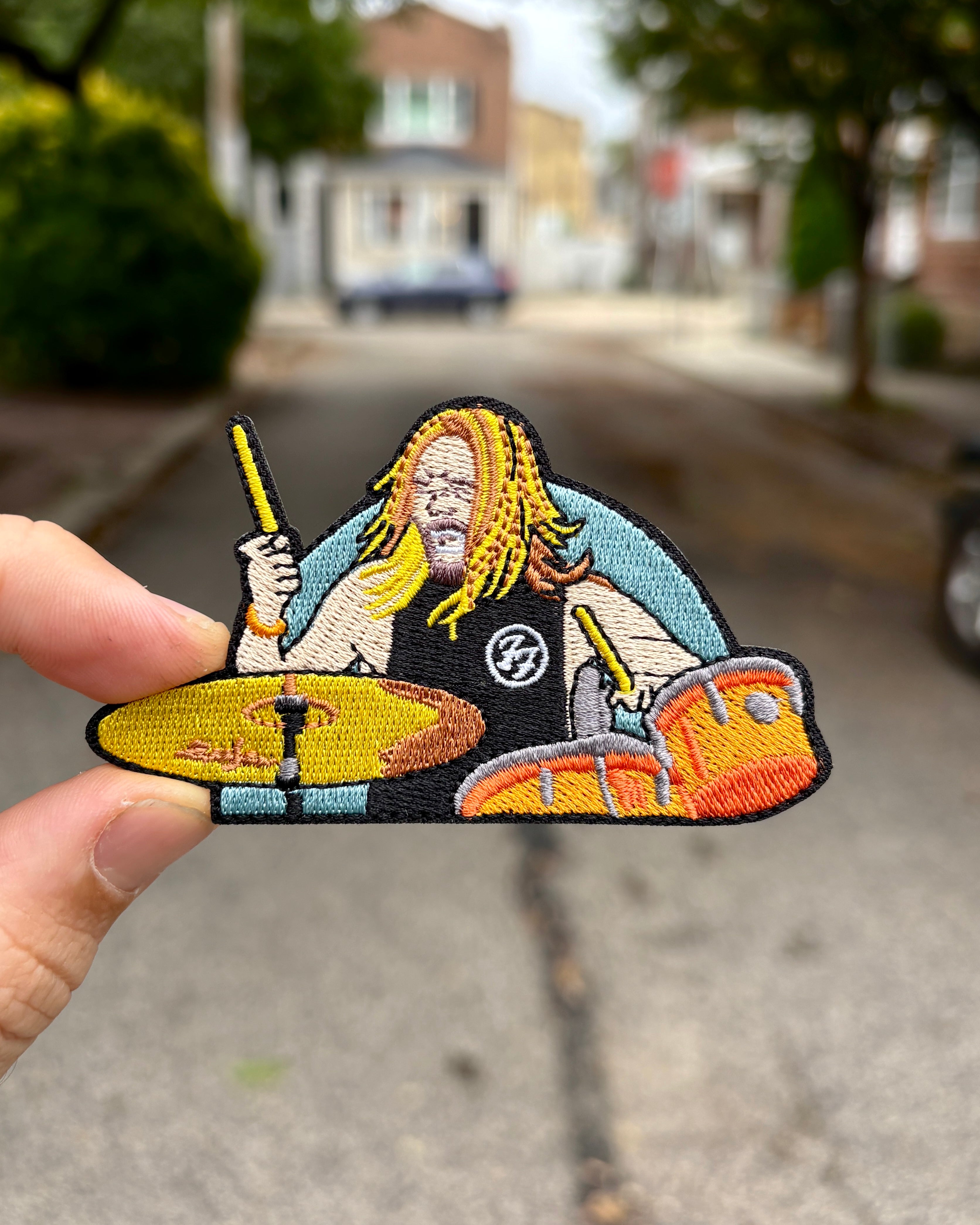 Taylor Hawkins Foo Fighters drummer embroidered patch held in hand