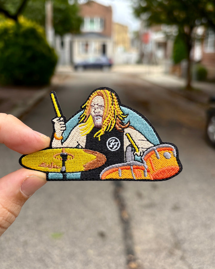 Taylor Hawkins Foo Fighters drummer embroidered patch held in hand
