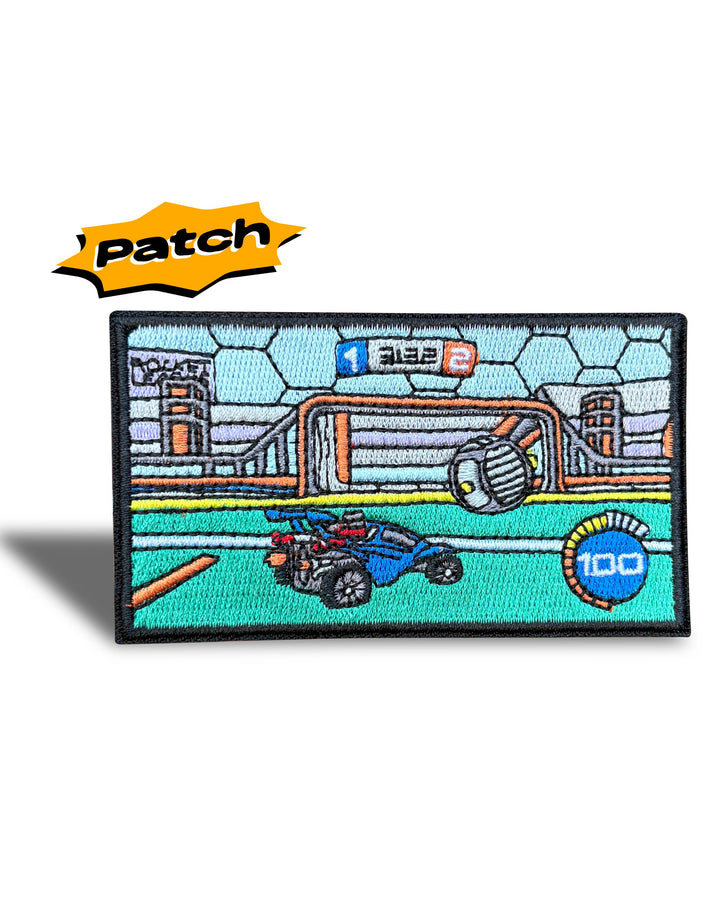 An embroidered rectangular patch featuring a stylized soccer scene with a blue ball, orange goal, green field, and a yellow 'Patch' label above it on a white background.